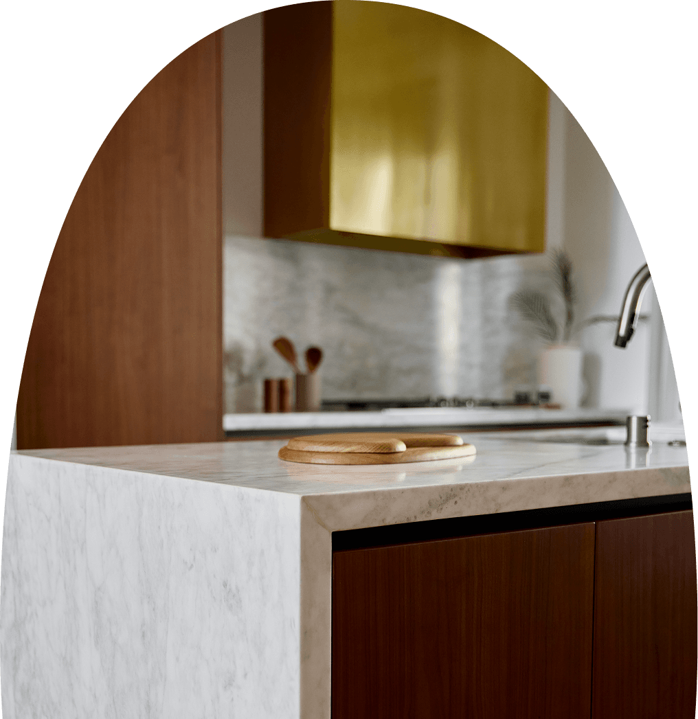 Close-up of kitchen finishes showing textured materials and refined surfaces such as stone, wood, and metal.