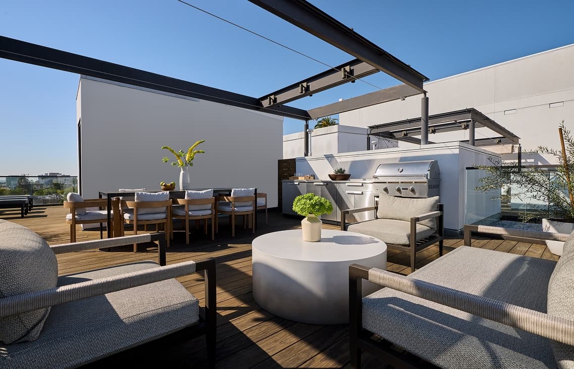 Outdoor terrace of a townhome with patio seating including seating area, outdoor dining area and an outdoor kichen